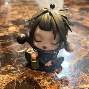 Cute Action Figure with Black and Green Accents